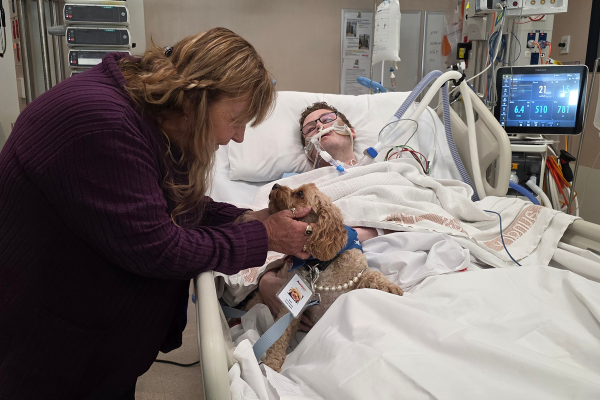 Austin Health ICU patient Robert and his aunt Leonie, with Lort Smith Pet Therapy dog Molly